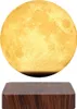 A floating moon lamp above a wooden base. Produktbild-Vorschau