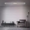 A modern living room with a brick wall, a sofa, a cabinet, and a floor lamp. Produktbild-Vorschau