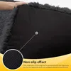 Close-up of the underside of a dark gray dog bed, highlighting its non-slip effect with a magnified inset and text overlay. Produktbild-Vorschau