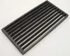 A dark, rectangular grate with parallel slots, shown from a slightly elevated angle against a white background. Podgląd zdjęcia produktu