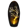 A decorative solar-powered lamp with a tree design. Produktbild-Vorschau