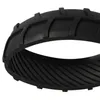 A close-up, studio shot of a black rubber tire tread. Produktbild-Vorschau
