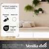 A graphic overlay with product information and certifications is placed on top of an image of a bed or daybed with pillows, with plants in the background. Produktbild-Vorschau