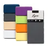 A stack of folded fitted sheets in various colors, with one sheet displayed upright with its packaging. Náhled obrázku produktu