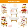 A collage of images showcasing multi-tiered serving stands filled with various food items like fruits, pastries, and snacks. Produktbild-Vorschau