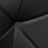 A close-up view of black quilted leather. Produktbild-Vorschau