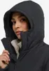 Close-up of a woman wearing a black hooded jacket with a beige lining. Produktbild-Vorschau