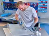 A man is working on a metal project in a workshop. Anteprima dell’immagine prodotto