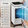 A white air cooler with blue light effects and a remote control, next to informational text. Náhled obrázku produktu