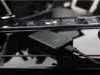 A black wireless CarPlay adapter is plugged into a car's console. Náhľad obrázku produktu