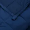 A close-up view of a quilted blue blanket. Náhľad obrázku produktu