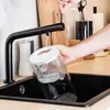 A person is filling a water filter pitcher under a black faucet in a kitchen sink. Anteprima dell’immagine prodotto
