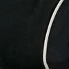 A close-up of a black fabric with a white stripe. Produktbild-Vorschau