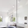 A modern bathroom with a bathtub, sink, and mirror, featuring ceiling lights. Podgląd zdjęcia produktu