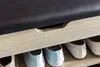 A close-up view of a shoe bench with a padded seat and shelves for shoes. Produktbild-Vorschau