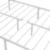 A close-up view of a white metal bed frame, showing the slatted base and support legs. Podgląd zdjęcia produktu