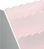 A close-up view of a pink and gray tiered shelf with a scalloped edge. Náhľad obrázku produktu