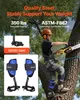 A person is climbing a tree using climbing gear and holding a chainsaw. Anteprima dell’immagine prodotto