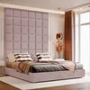 A bedroom scene with a large bed featuring a pink upholstered headboard and patterned pillows. Anteprima dell’immagine prodotto