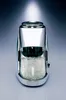 A chrome-plated ice crusher filled with crushed ice, set against a gradient background. Náhled obrázku produktu