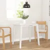 A white round dining table with two chairs in a bright room with a window. Náhľad obrázku produktu