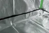 A close-up view of the interior of a grow tent, showing the reflective silver lining and a green zipper. Produktbild-Vorschau