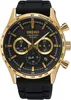 A close-up, front-facing studio shot of a gold and black Seiko chronograph watch with a black rubber strap. Náhled obrázku produktu