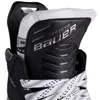 Close-up view of the top part of a black ice hockey skate, showing the Bauer logo and laces. Podgląd zdjęcia produktu