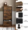 A tall, narrow dresser with five drawers, shown in a room setting with a rug and a clock on top. The right side of the image contains close-up shots and diagrams illustrating product features. Produktbild-Vorschau