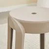 A close-up view of a beige stool. Voir les images du produit