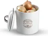 A white ceramic onion storage container filled with onions, with the lid slightly ajar. Produktbild-Vorschau