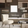 A modern living room scene featuring a sectional sofa, an armchair, and a coffee table, with a square LED panel mounted on the wall. Produktbild-Vorschau
