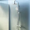 A modern shower system mounted on a light blue wall, with a glass partition on the left. Produktbild-Vorschau