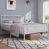 A white metal bed frame with a mattress and bedding is shown in a bedroom setting. Produktbild-Vorschau