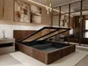 A bedroom with a brown upholstered bed frame, its storage compartment open, revealing wooden slats. Two abstract paintings hang on the wall above the headboard, and a modern chandelier is visible. Podgląd zdjęcia produktu