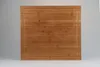 A top-down view of a square bamboo cutting board with a subtle groove around the edge, set against a light gray background. Produktbild-Vorschau