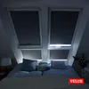 A bedroom with skylights covered by blackout blinds, with pillows and a bed in the foreground. Produktbild-Vorschau