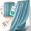 A close-up of a blue curtain with a tag and a certification label. Produktbild-Vorschau