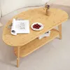 A bamboo coffee table with a book, glass of water, and cherries on top, placed on a light-colored floor. Voir les images du produit