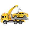 A toy tow truck with a toy taxi on its flatbed. Anteprima dell’immagine prodotto
