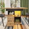 A dining table with storage and LED lighting, set in a dining room with chairs and a plant. Produktbild-Vorschau
