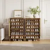 Two wooden shoe cabinets filled with shoes, placed in a room with a couch and a door. Produktbild-Vorschau