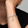 A close-up shot of a person's arm wearing a silver Pandora charm bracelet with a stethoscope-shaped charm. Produktbild-Vorschau