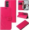 A collage of images showing a pink flip phone case with floral and butterfly designs. Produktbild-Vorschau