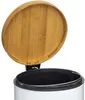 A white trash can with an open bamboo lid. Anteprima dell’immagine prodotto