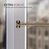 Close-up of a gold-colored cafe curtain rod attached to a white window frame. Podgląd zdjęcia produktu
