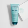 A product shot of a hair cream tube with a dollop of cream next to it. Náhľad obrázku produktu