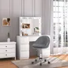 A vanity set with a chair in a room with a window. Produktbild-Vorschau
