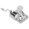 A close-up, studio shot of a music box mechanism with a hand crank. Voir les images du produit