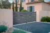A modern aluminum double gate in a driveway in front of a house. Produktbild-Vorschau